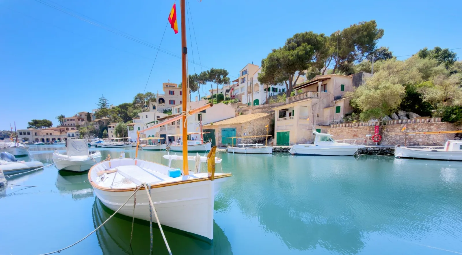 Traditional wooden llaüt boats moored in a small Mallorcan fishing harbour