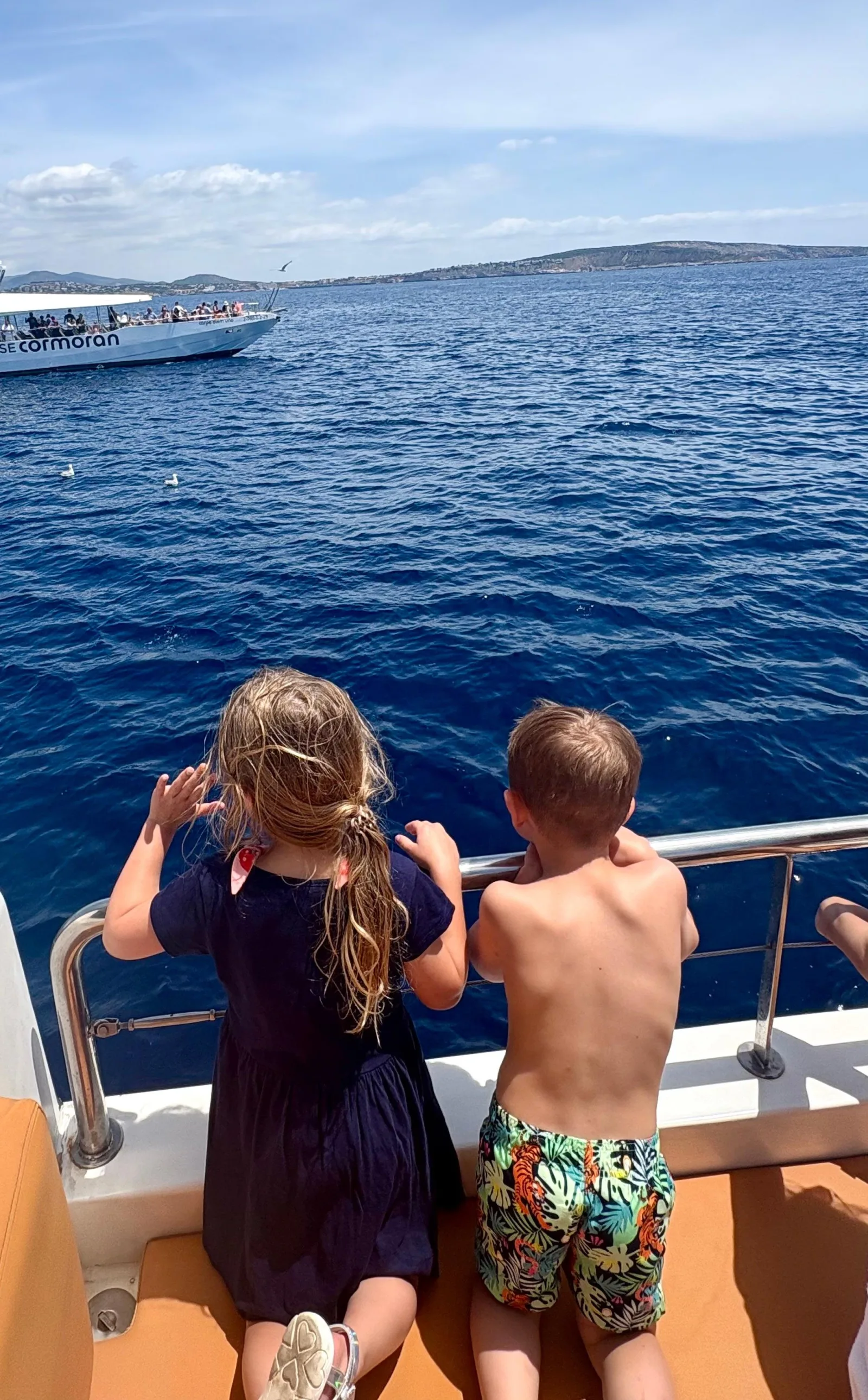 Two children at the bow rail looking out over the Bay of Palma