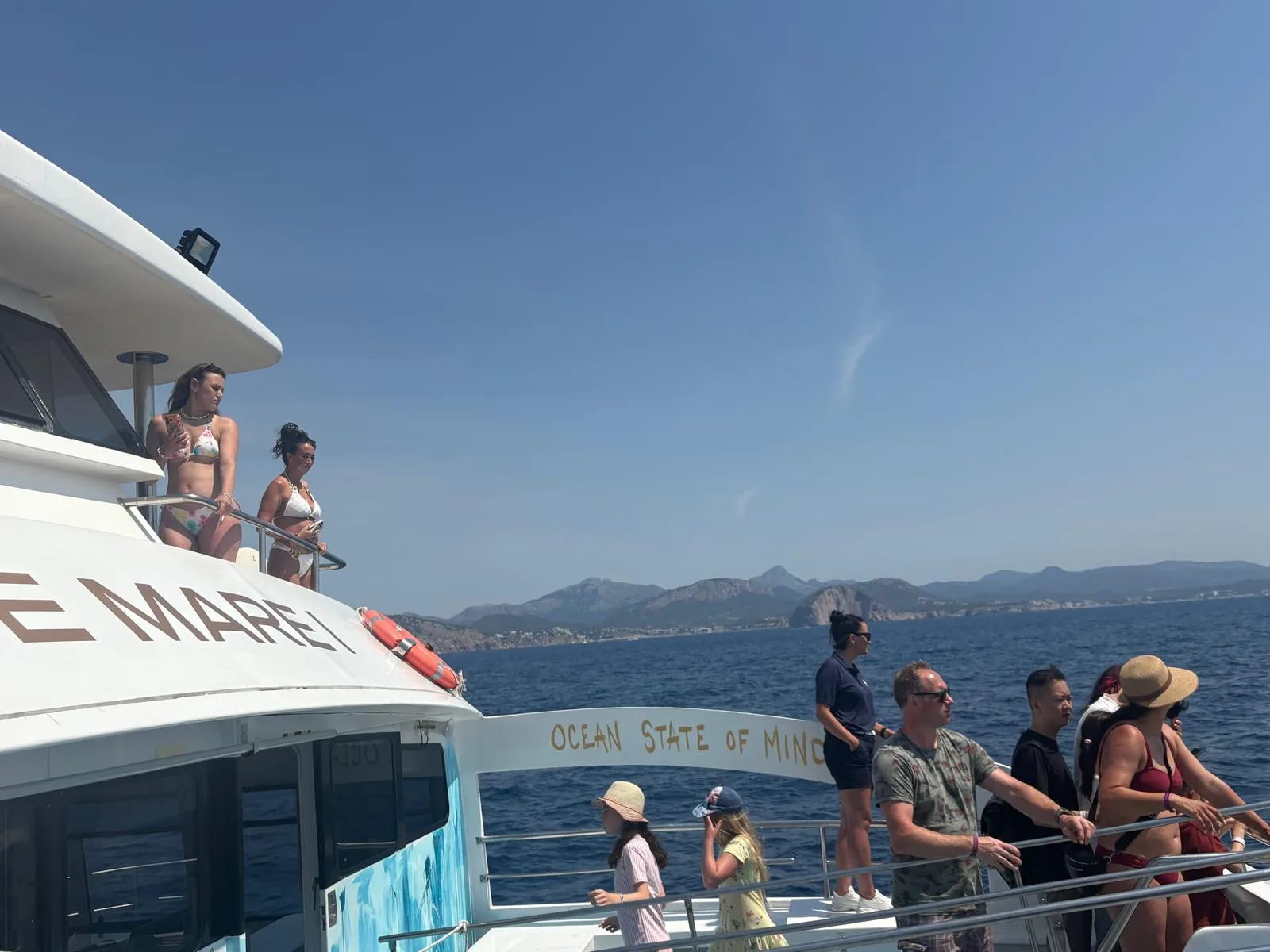 Guests on the upper deck as the boat passes the Mallorcan coastline