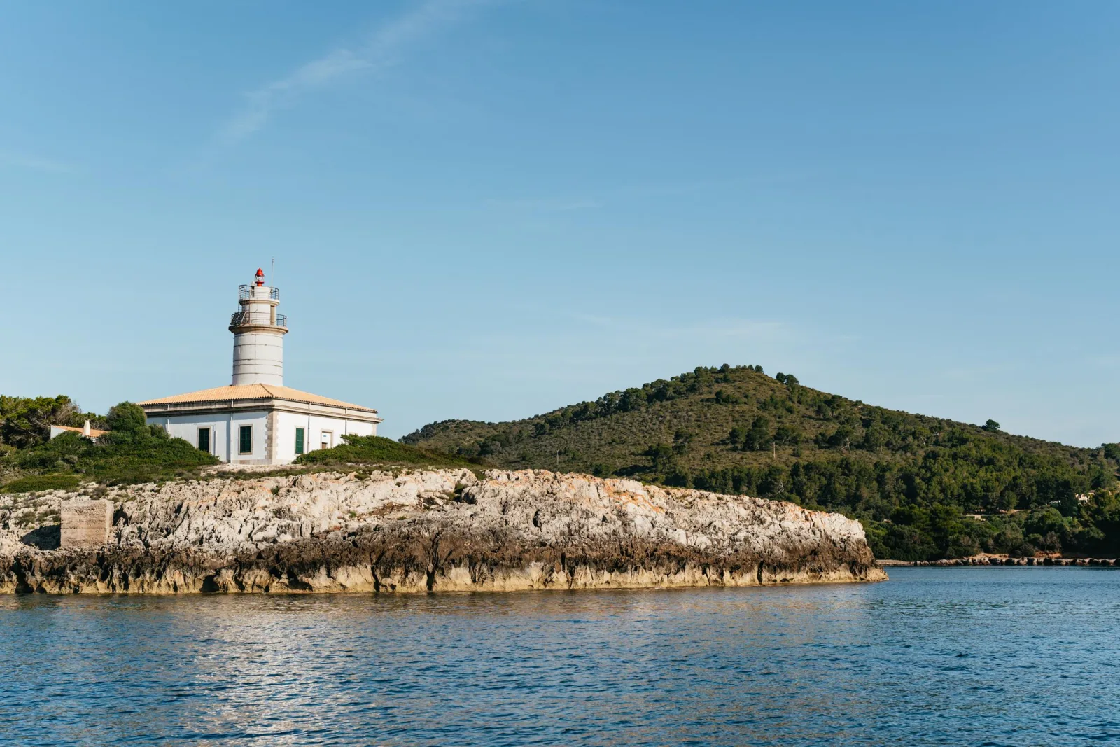 The lighthouse on the Alcanada headland seen from the water off Alcúdia