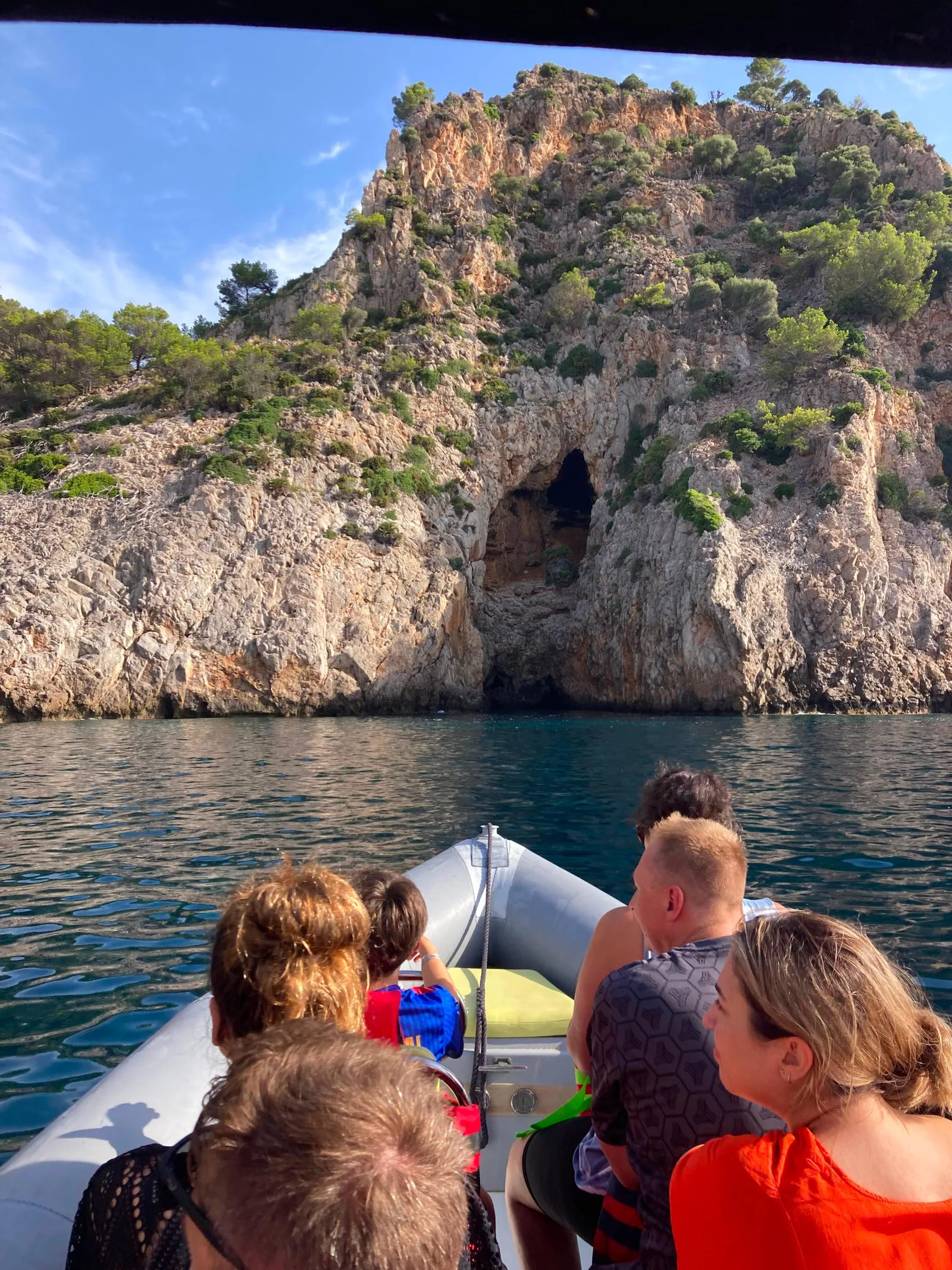Guests looking up at the cliffs and sea caves of the north coast